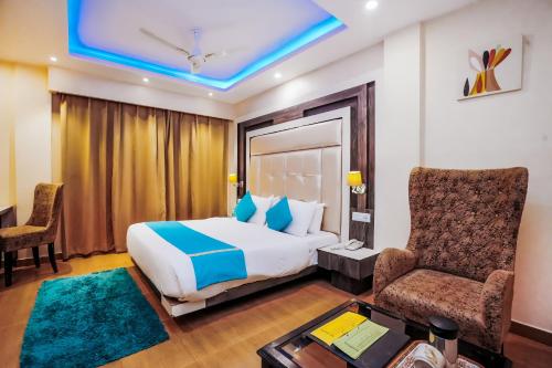 a hotel room with a bed and a chair at Himalayan Mountain and Valley View - Garden with bonefire - Ample Parking - Luxury Balcony rooms -by Aachman Stays!! Mashobra in Shimla