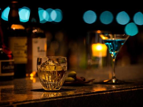 a glass of water sitting on a table with a wine glass at Villa Fontaine Premier Haneda Airport in Tokyo