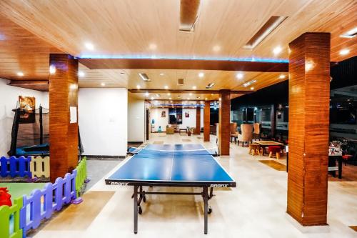 a ping pong table in the middle of a room at Himalayan Mountain and Valley View - Garden with bonefire - Ample Parking - Luxury Balcony rooms -by Aachman Stays!! Mashobra in Shimla