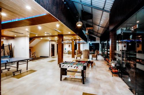 a room with a pool table and ping pong tables at Himalayan Mountain and Valley View - Garden with bonefire - Ample Parking - Luxury Balcony rooms -by Aachman Stays!! Mashobra in Shimla