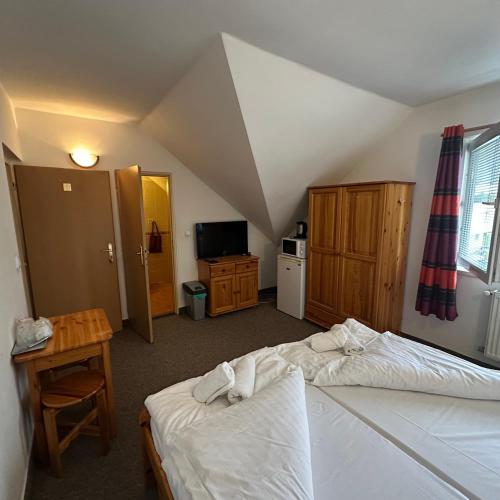 an attic bedroom with two beds and a room with at Penzión Tandem in Martin