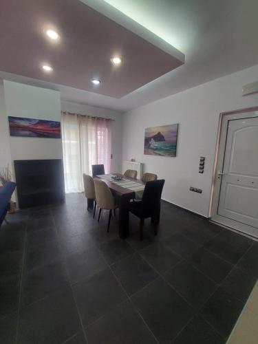 a dining room with a table and chairs at Ammos Family Villa in Daratso