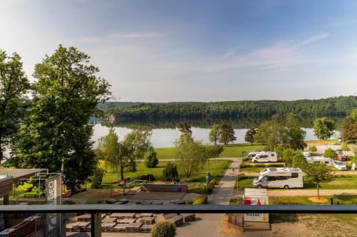 a view of a parking lot and a lake at Vranovská pláž - Holiday park in Vranov nad Dyjí