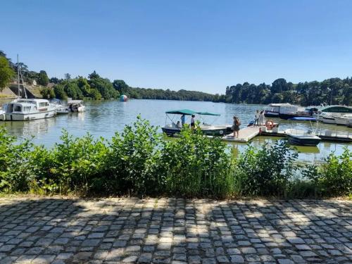 a group of boats docked at a dock on a lake at Gite du Clos Martin in Drefféac