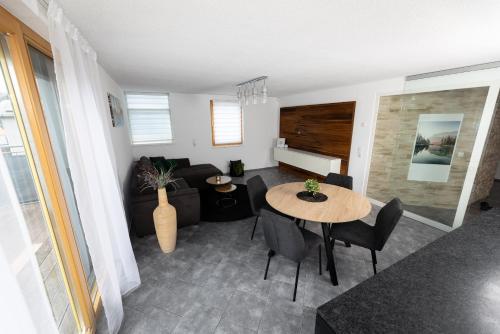 a living room with a table and a couch at Riedwohnung 1- Lustenau in Lustenau