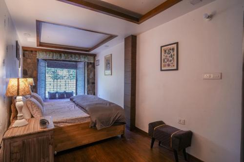 a bedroom with a large bed and a window at Woodburry Mansion, Cozy Nainital Homestay in Nainital