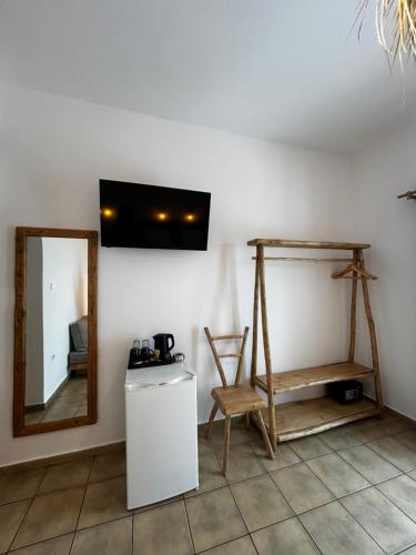 a room with a mirror and a table and a chair at Hotel Livadia in Parikia
