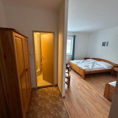 a room with a bedroom with a bed and a door at Penzión Tandem in Martin