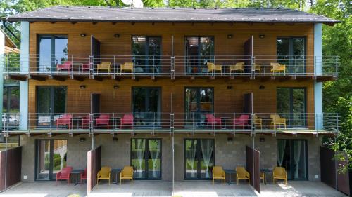 a house with chairs and tables on the balcony at Vranovská pláž - Holiday park in Vranov nad Dyjí