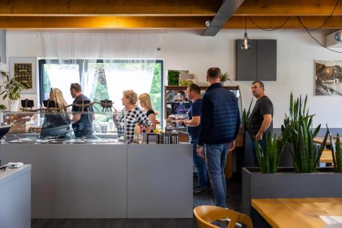 a group of people standing around a counter in a kitchen at Vranovská pláž - Holiday park in Vranov nad Dyjí