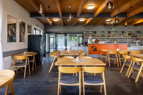 a restaurant with wooden tables and chairs at Vranovská pláž - Holiday park in Vranov nad Dyjí