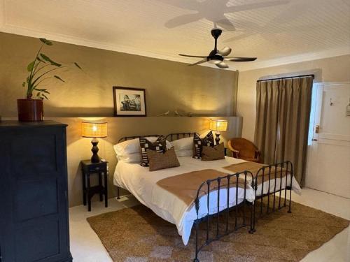 a bedroom with a bed and a ceiling fan at The Lady Grace in Greyton