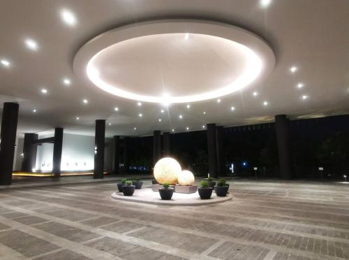a large lobby with a large light hanging from the ceiling at The Apple Melaka in Melaka