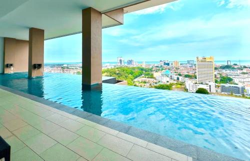 a swimming pool with a view of a city at The Apple Melaka in Melaka