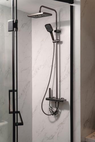 a shower with a shower head in a bathroom at Cloud 22Land hotel in Hanoi