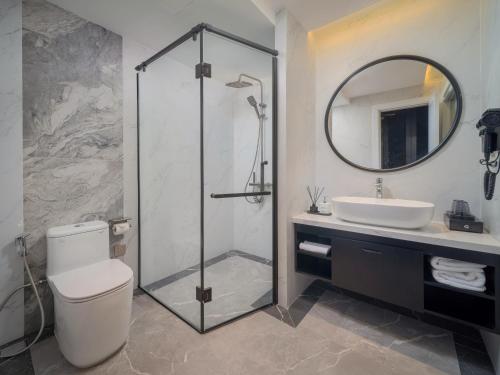 a bathroom with a shower and a toilet and a sink at Cloud 22Land hotel in Hanoi