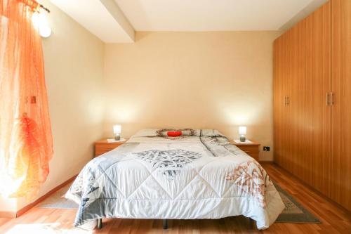 a bedroom with a bed with two night stands and two lamps at La Ghiacciaia in Verzuolo