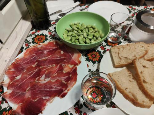 a plate of food with meat and bread and a bowl of peas at Bonaventura b&b and Bonaventura food in Tollo