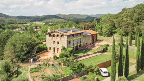 an aerial view of a large stone house with trees at Aiguabella - Allotjaments Rurals in Sant Felíu de Pallarols