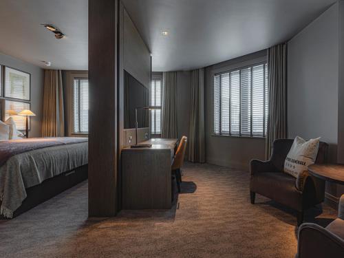 a bedroom with a bed and a desk and a chair at Dakota Newcastle in Newcastle upon Tyne