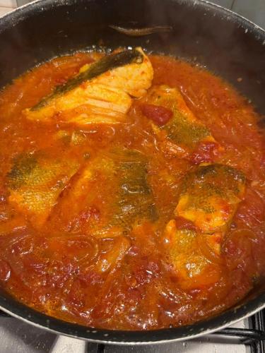 a pan of food with chicken in a stew at Bonaventura b&b and Bonaventura food in Tollo