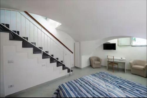 a white room with a staircase and a bed at Secret Garden Amalfi Coast in Atrani