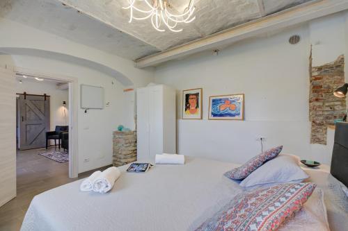 a bedroom with a large bed with towels on it at In Bocca Al Lupo with Shared Pool in Clavesana