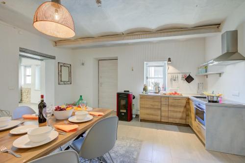 a kitchen and dining room with a table and chairs at In Bocca Al Lupo with Shared Pool in Clavesana