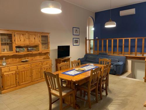 a living room with a table and a couch at Villa LINA in Lido Di Fondi