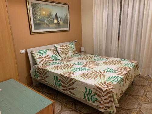 a bedroom with a bed and a couch in it at Villa LINA in Lido Di Fondi