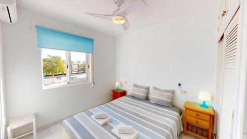 a bedroom with a bed and a window at Holidoo Travel Casa Dorada in Los Alcázares
