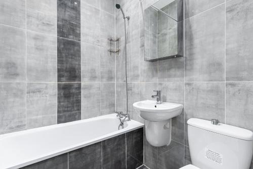 a bathroom with a toilet and a sink and a shower at Camden Apartments in London