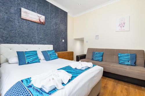 a bedroom with a bed and a couch at Camden Apartments in London