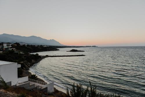 a view of a body of water with a beach at Sunside Inn Hotel in Kérynia