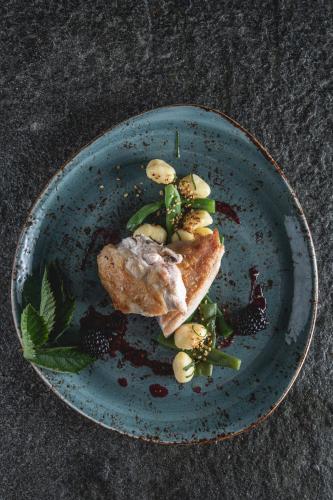 a blue plate with a piece of food on it at Bio-Landhotel Moarwirt in Dietramszell
