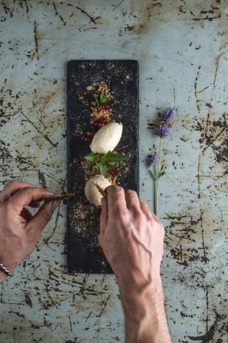 a person cutting up food on a cutting board at Bio-Landhotel Moarwirt in Dietramszell