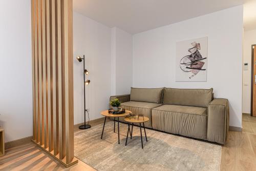 a living room with a couch and a table at SB Nest Studio in Braşov