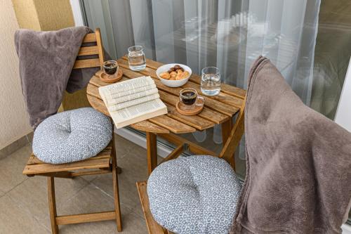 a wooden table with two chairs and a bowl of food at SB Nest Studio in Braşov