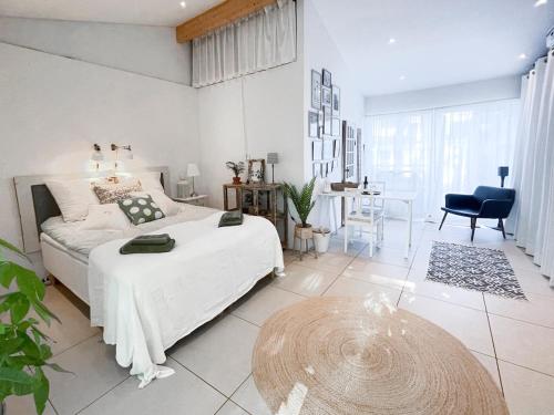 a bedroom with a bed and a table in it at Modern Guest House Downtown Ystad in Ystad