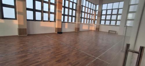 an empty room with windows and a wooden floor at The Anchorage Grand Colombo AT TRI-ZEN COLOMBO 02 in Colombo