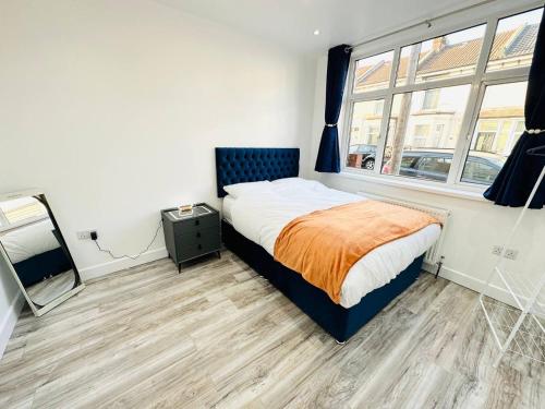 a bedroom with a bed and a large window at Room in Portsmouth in Portsmouth
