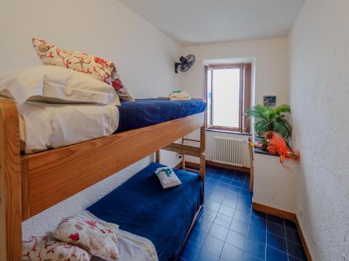 a bedroom with two bunk beds and a window at Il Baluardo Sea View Apartment on the Cliff in Manarola