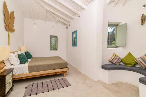 a bedroom with a bed and a bench in a room at Villa Thea by Villa Plus in Skinária