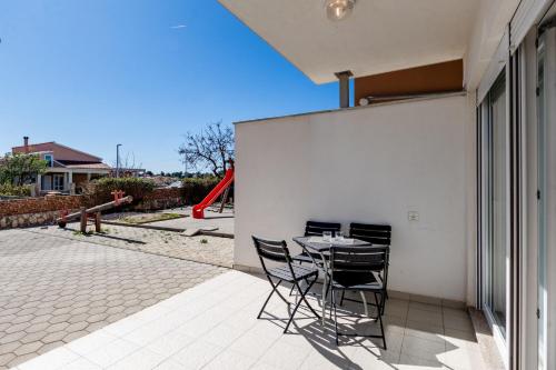 a patio with a table and chairs on the side of a building at Apartment Village Nin in Nin