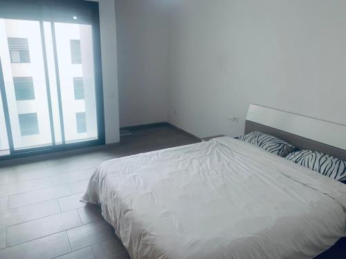 Ένα ή περισσότερα κρεβάτια σε δωμάτιο στο Appartement avec une Chambre, Salon, Salle de Bain et Piscine