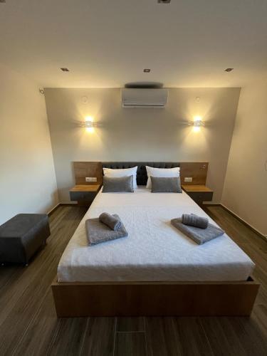 a bedroom with a large bed with two pillows on it at Victoria's Apartments in Néa Tríglia