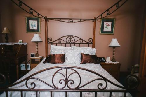 a bedroom with a large bed with white sheets and pillows at The Inn at Dresden in Dresden