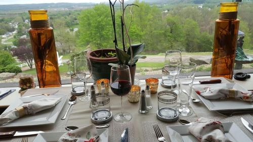 a table with wine glasses on it with a view at The Inn at Dresden in Dresden