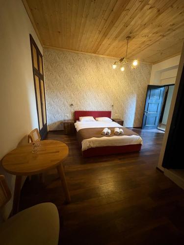 a bedroom with a bed and a table in it at Local Hotel in Tbilisi City