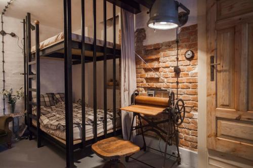 a room with a bunk bed and a wooden chair at Apartment by the cathedral II in Lublin